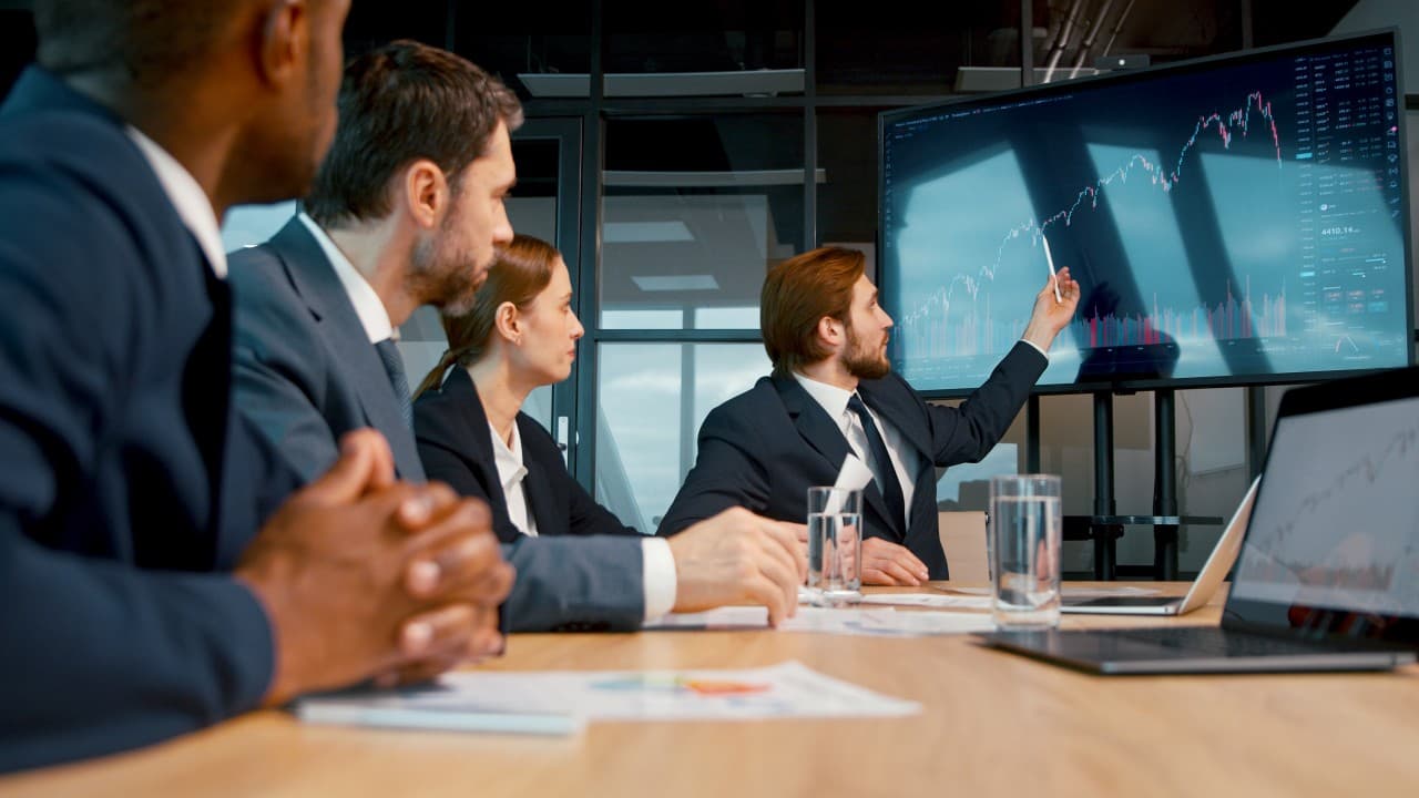 A small team reviewing figures on a shared screen